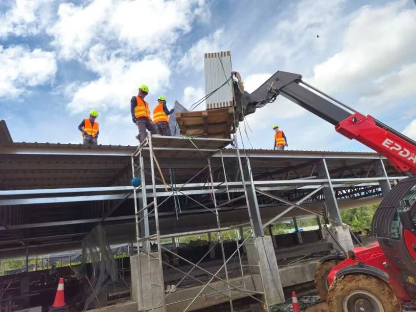 Telehandler placing building material at a construction site